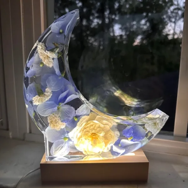 Crescent moon resin art piece with flowers