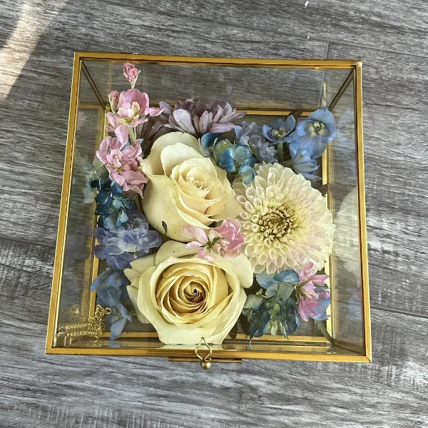 Preserved bridal bouquet displayed in a glass shadow box
